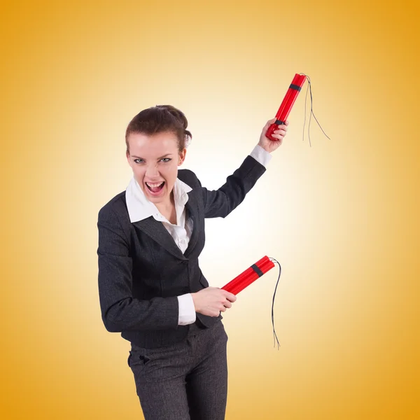 Businesswoman with dynamite against the gradient — Stock Photo, Image