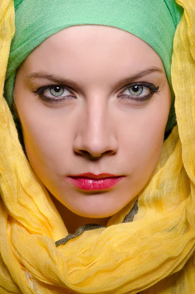 Serious woman wearing colourful headscarf — Stock Photo, Image