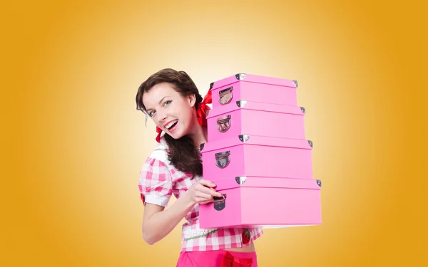 Young woman with storage boxes against the gradient — Stock Photo, Image