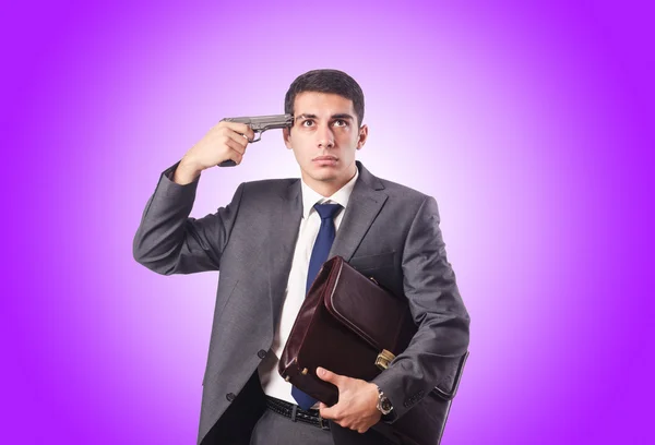 Businessman thinking of suicide against gradient — Stock Photo, Image