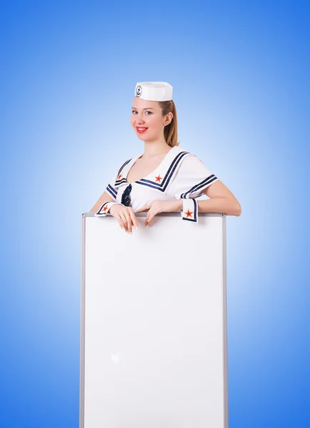 Woman sailor with blank board against the gradient — Stock Photo, Image