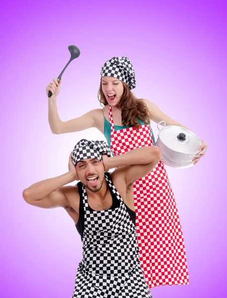 Pair of funny cooks against gradient — Stock Photo, Image
