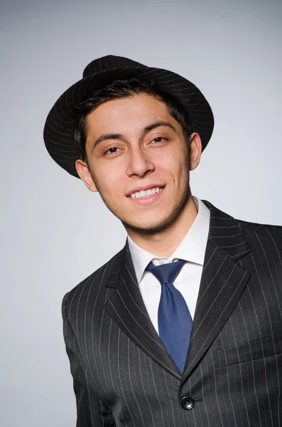 Young attractive smiling gansgter in hat and suit — Stock Photo, Image