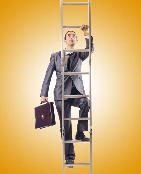 Businessman climbing the ladder against the gradient — Stock Photo, Image