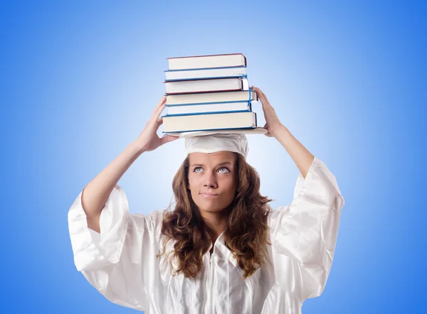 Graduate with book against the gradient — Stock Photo, Image