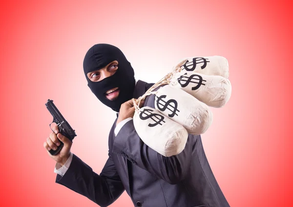 Gangster with bags of money against the gradient — Stock Photo, Image