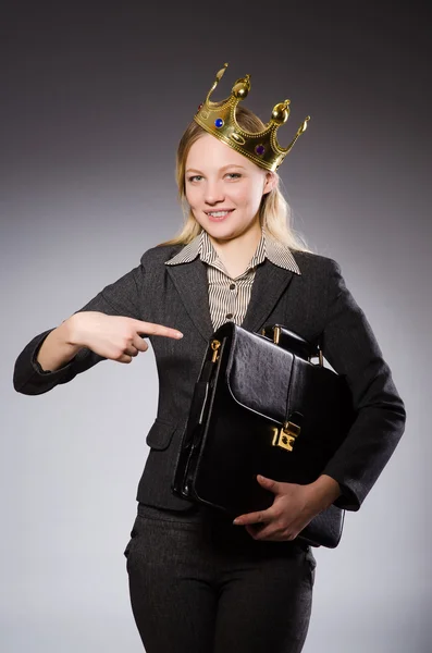 Pretty businessman with crown and case isolated on gray — Stock Photo, Image