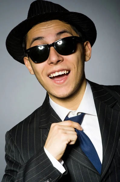 Young man in classic striped costume and hat isolated on gray — Stock Photo, Image