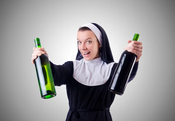 Nonne mit Flasche Rotwein — Stockfoto