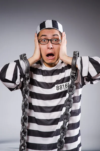 Funny prisoner in chains isolated on gray — Stock Photo, Image