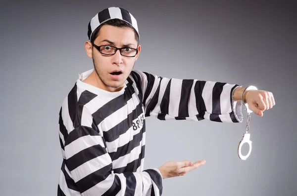 Funny prisoner in handcuffs isolated on gray — Stock Photo, Image