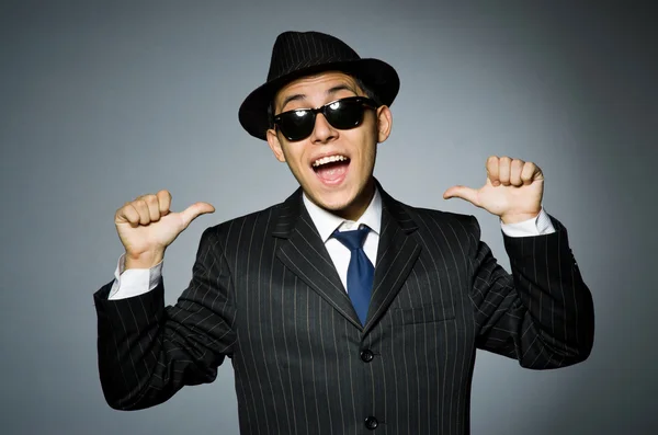 Young man in classic striped costume and hat isolated on gray — Stock Photo, Image