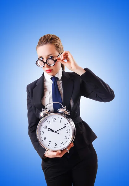 Nerd businesswoman with giant alarm clock — Stock Photo, Image