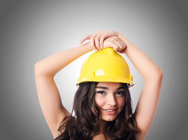 Young woman with yellow hard hat — Stock Photo, Image