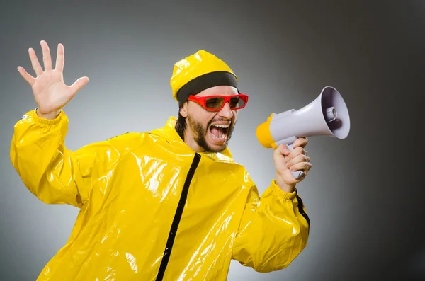 Man wearing yellow suit with loudspeaker — Stock Photo, Image