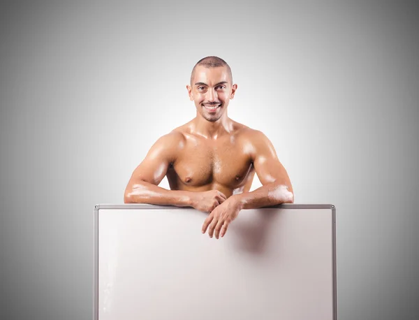 Half naked man with blank board — Stock Photo, Image