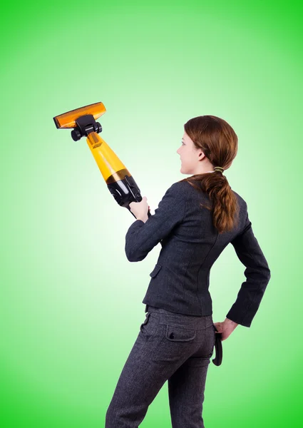 Young woman with vacuum cleaner against gradient — Stock Photo, Image