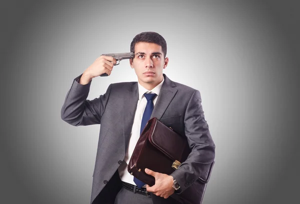 Businessman thinking of suicide against gradient — Stock Photo, Image