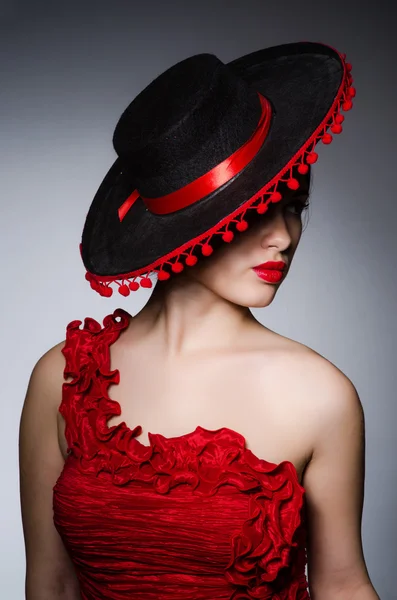 Woman wearing hat against dark background — Stock Photo, Image