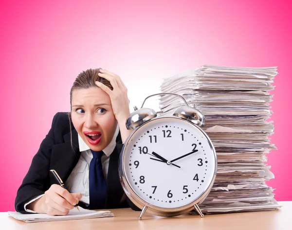 Businesswoman with giant alarm clock — Stock Photo, Image