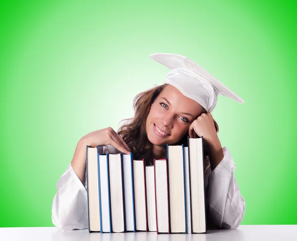 Graduate with book against the gradient — Stock Photo, Image