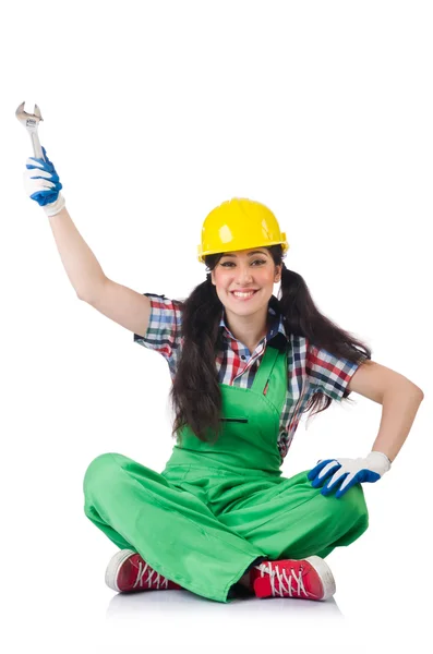 Lavoratrice in tuta verde con chiave isolata su bianco — Foto Stock