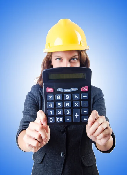 Female builder with calculator against the gradient — Stock Photo, Image