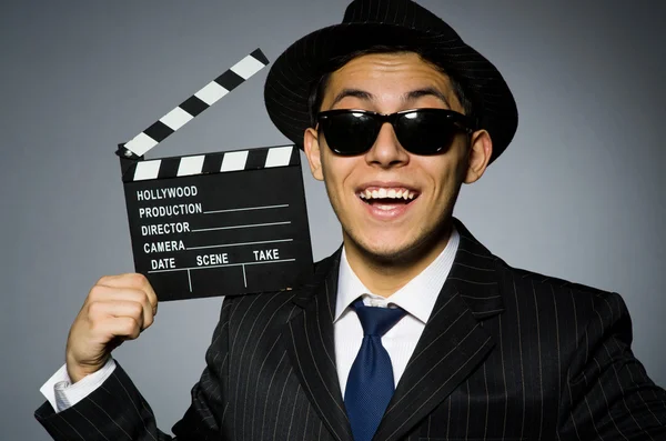 Young man in classic striped costume and hat isolated on gray — Stock Photo, Image