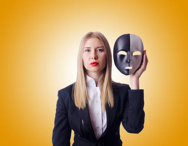 Woman with mask in hypocrisy concept — Stock Photo, Image