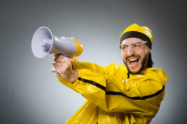Man wearing yellow suit with loudspeaker — Stock Photo, Image