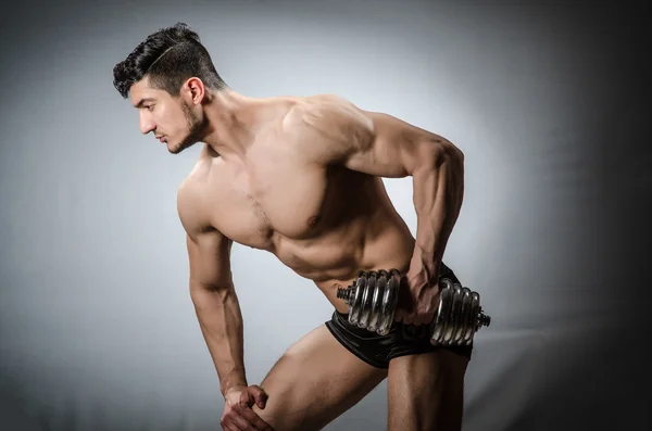 Gespierde geripte bodybuilder met halters — Stockfoto