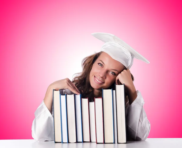 Graduate with book against the gradient — Stock Photo, Image