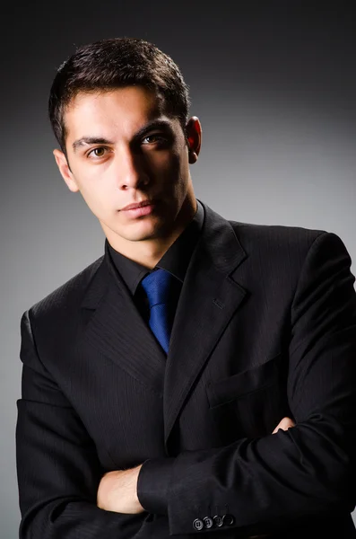Young elegant man against gray — Stock Photo, Image