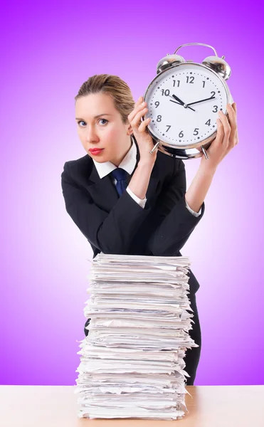 Businesswoman with giant alarm clock — Stock Photo, Image