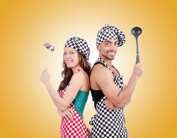 Pair of funny cooks against gradient — Stock Photo, Image