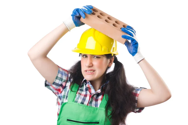 Vrouwelijke workman in groene overall houden baksteen geïsoleerd op wit — Stockfoto