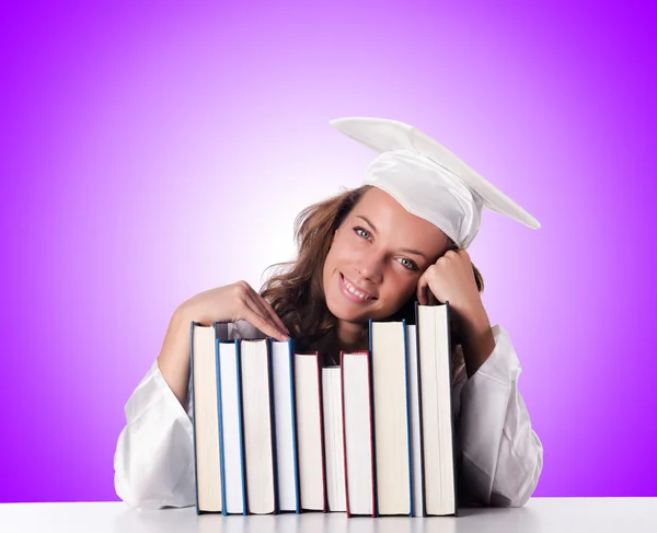 Graduate with book against the gradient — Stock Photo, Image