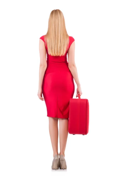 Blondýnka v červených šatech s kufrem — Stock fotografie