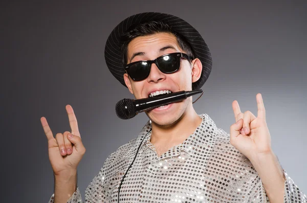 Young cheerful singer with microphone — Stock Photo, Image