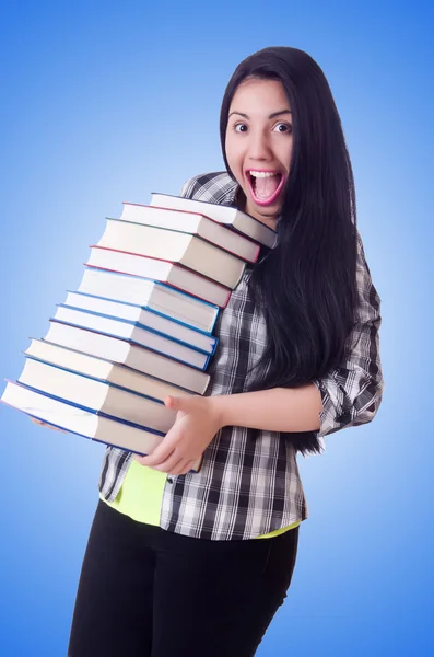 Studentin mit Büchern auf blau — Stockfoto