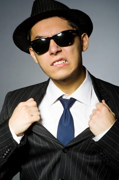 Young man in elegant suit against gray — Stock Photo, Image