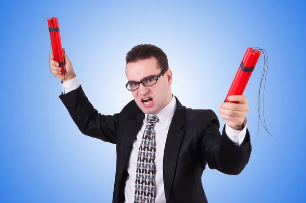 Businessman with dynamite on blue — Stock Photo, Image