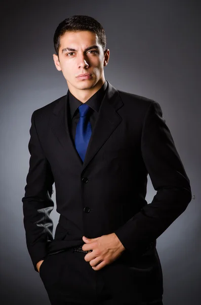 Joven hombre elegante contra gris — Foto de Stock