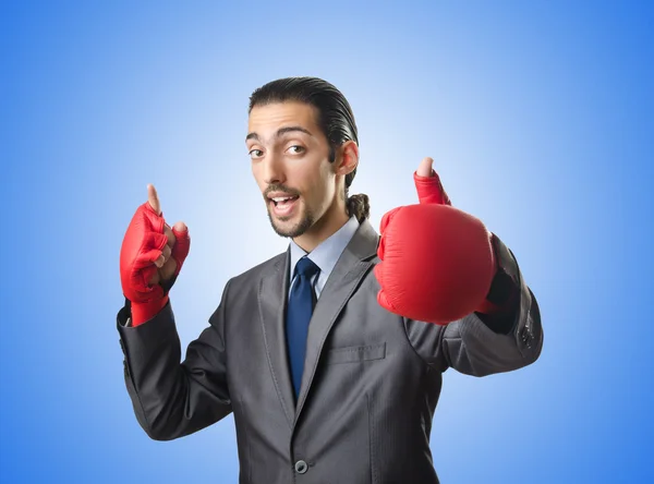 Handsome businessman with boxing gloves — Stock Photo, Image