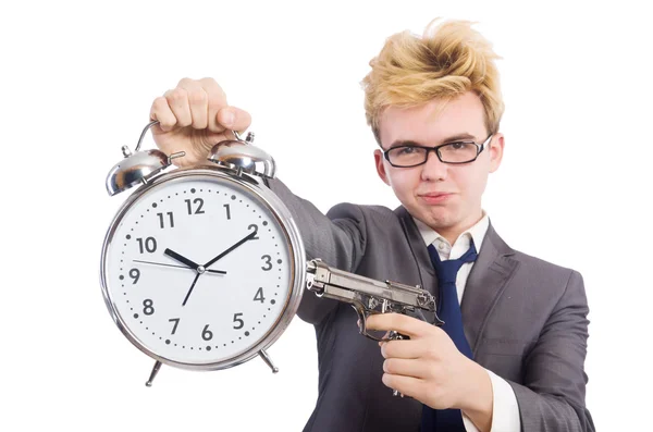 Joven hombre de negocios pistola holidng y reloj despertador aislado en blanco —  Fotos de Stock