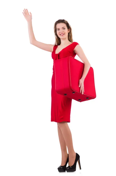 Giovane donna in abito rosso con valigia isolata su bianco — Foto Stock