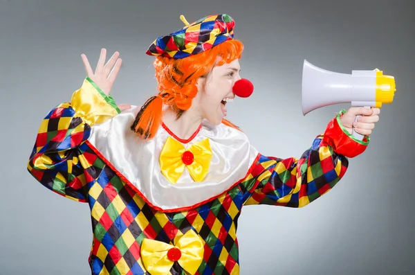 Clown with loudspeaker against the gradient — Stock Photo, Image