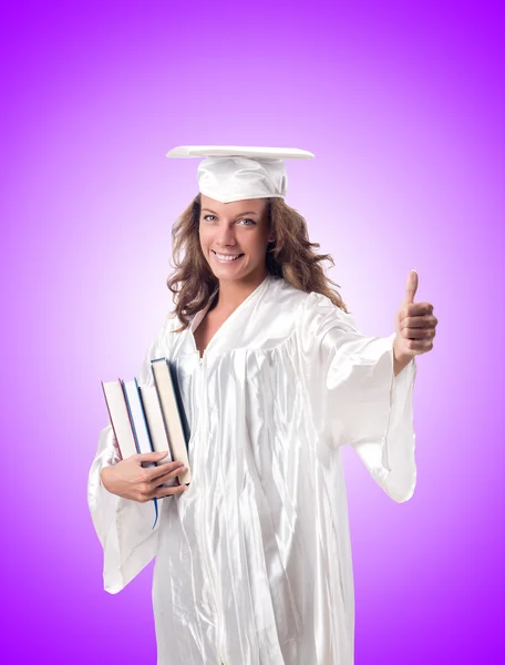 Graduado con libro contra el gradiente — Foto de Stock