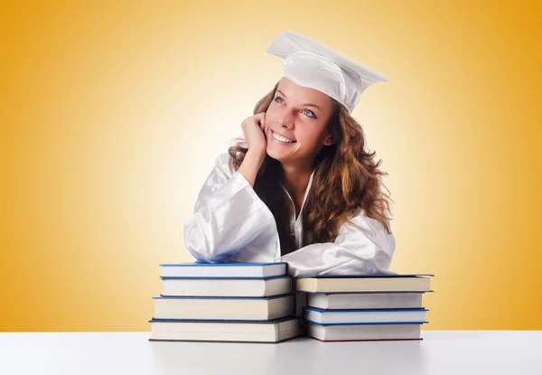 Happy graduate with lots of books — Stock Photo, Image