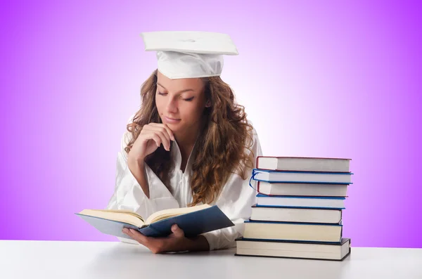 Happy graduate with lots of books — Stock Photo, Image